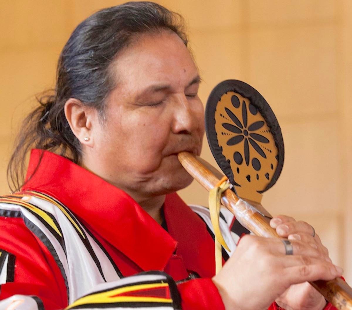 Close-up of Walter playing a traditional wooden flute